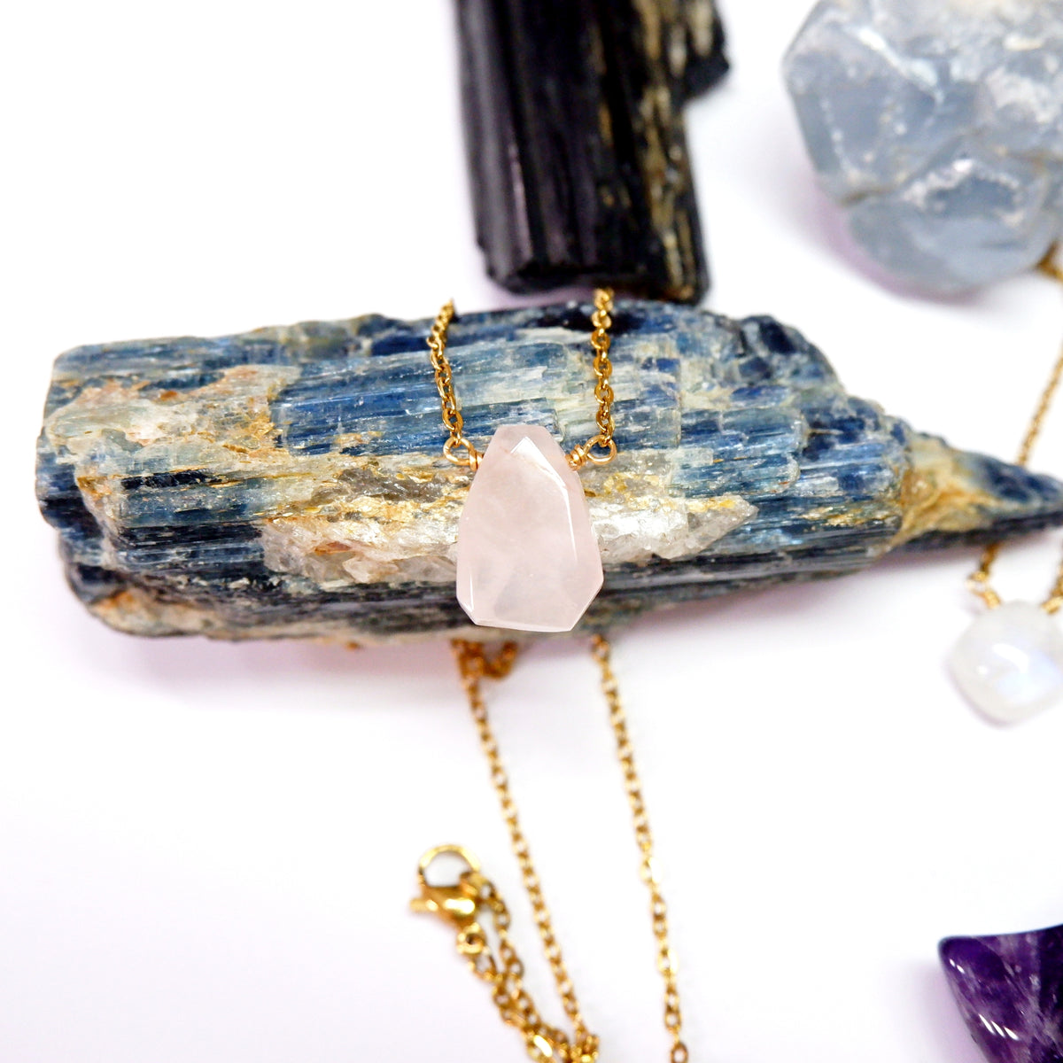 Necklace with a pink crystal pendant on a white background