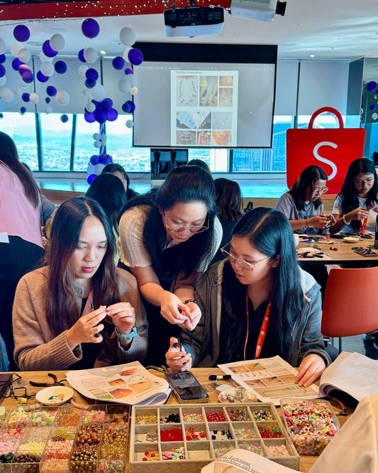 	Shopee Philippines employees participating in a hands-on jewelry-making workshop facilitated by Made by KCA.
