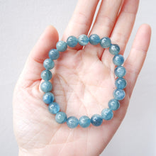 Blue Green Kyanite beaded bracelet on a hand against a light background