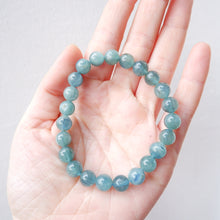 blue green kyanite beaded bracelet on a hand against a light background
