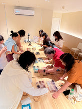 Participants choosing natural crystals for a personalized bracelet