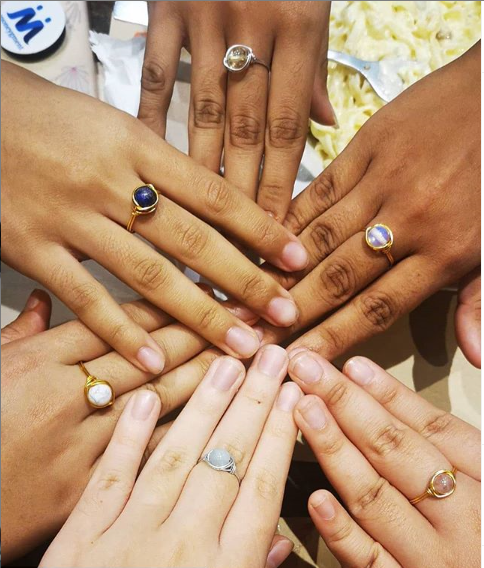 A collage of images showing various hands wearing rings with different crystal beads.