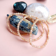 Handmade sunstone bracelet by Made by KCA featuring round peach-orange Sunstone beads strung on a durable stretch cord.